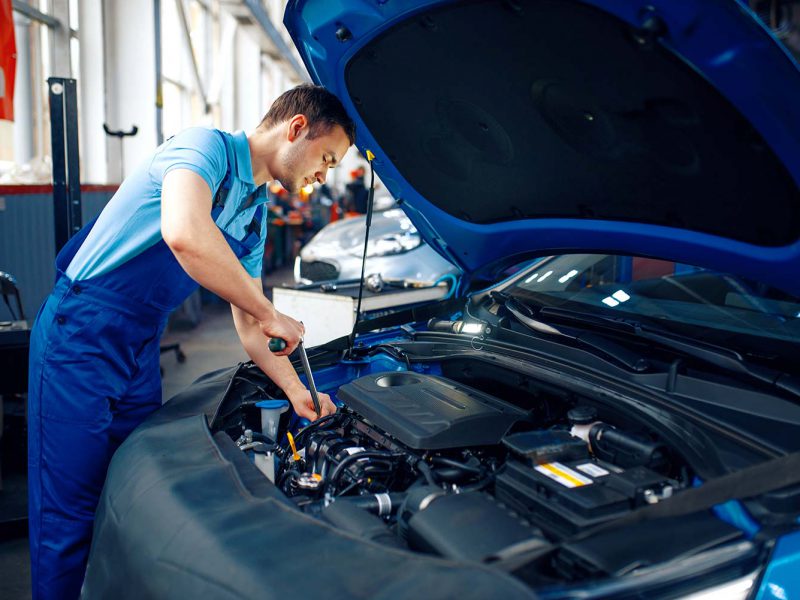 worker-in-uniform-checks-engine-car-service-small.jpg